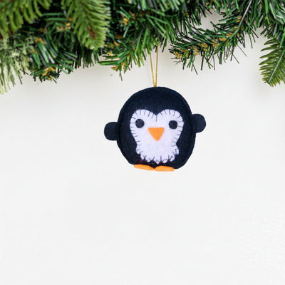 Felt penguin ornament hanging on a Christmas tree