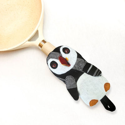 Puffin-shaped oven mitt on a white background