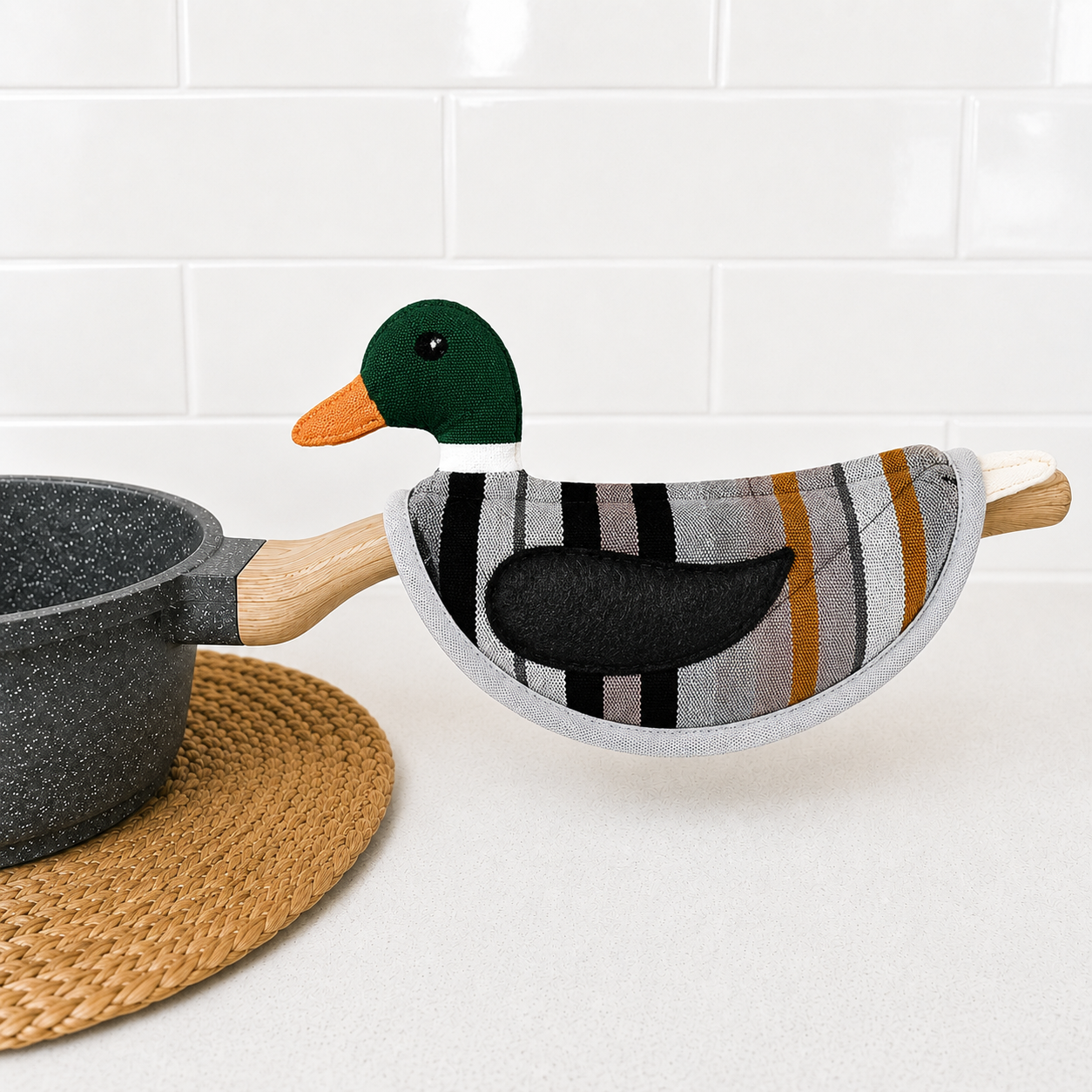 Duck-shaped pot holder with a striped pattern on a white surface